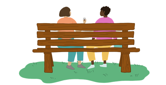 Two people sitting on a bench chatting - carers